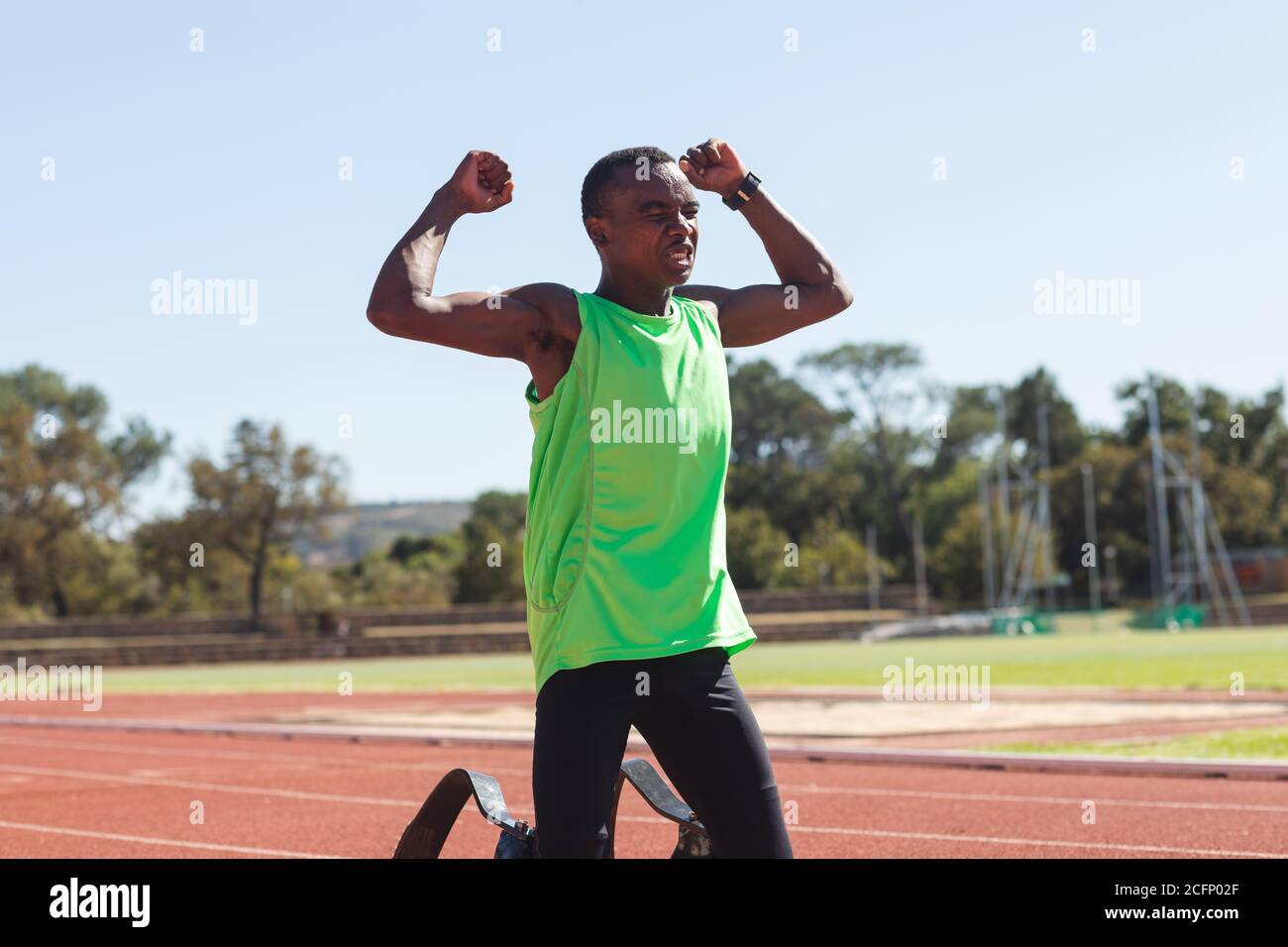 Male athlete with prosthetic leg celebrating on race track Stock Photo ...
