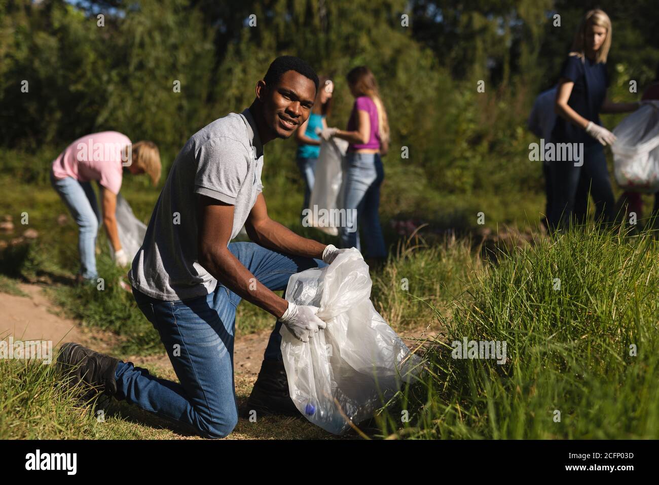 Volunteers cleaning up river in the countryside Stock Photo
