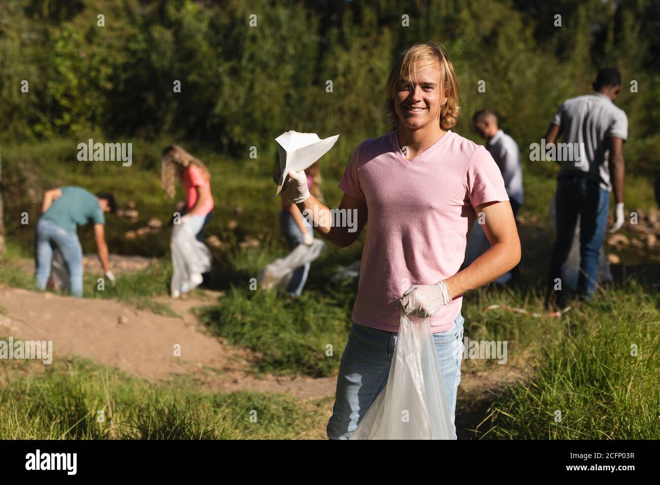 Volunteers cleaning up river in the countryside Stock Photo