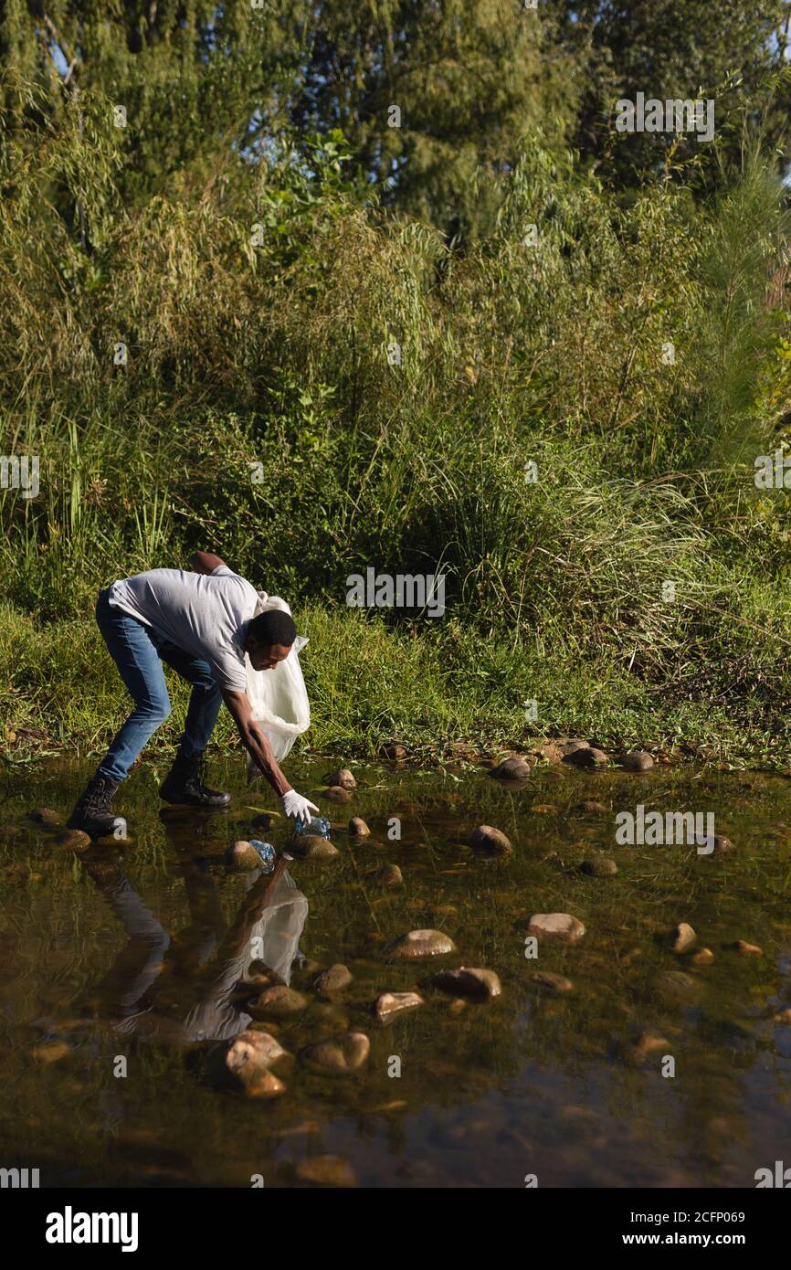 Volunteer cleaning up river in the countryside Stock Photo