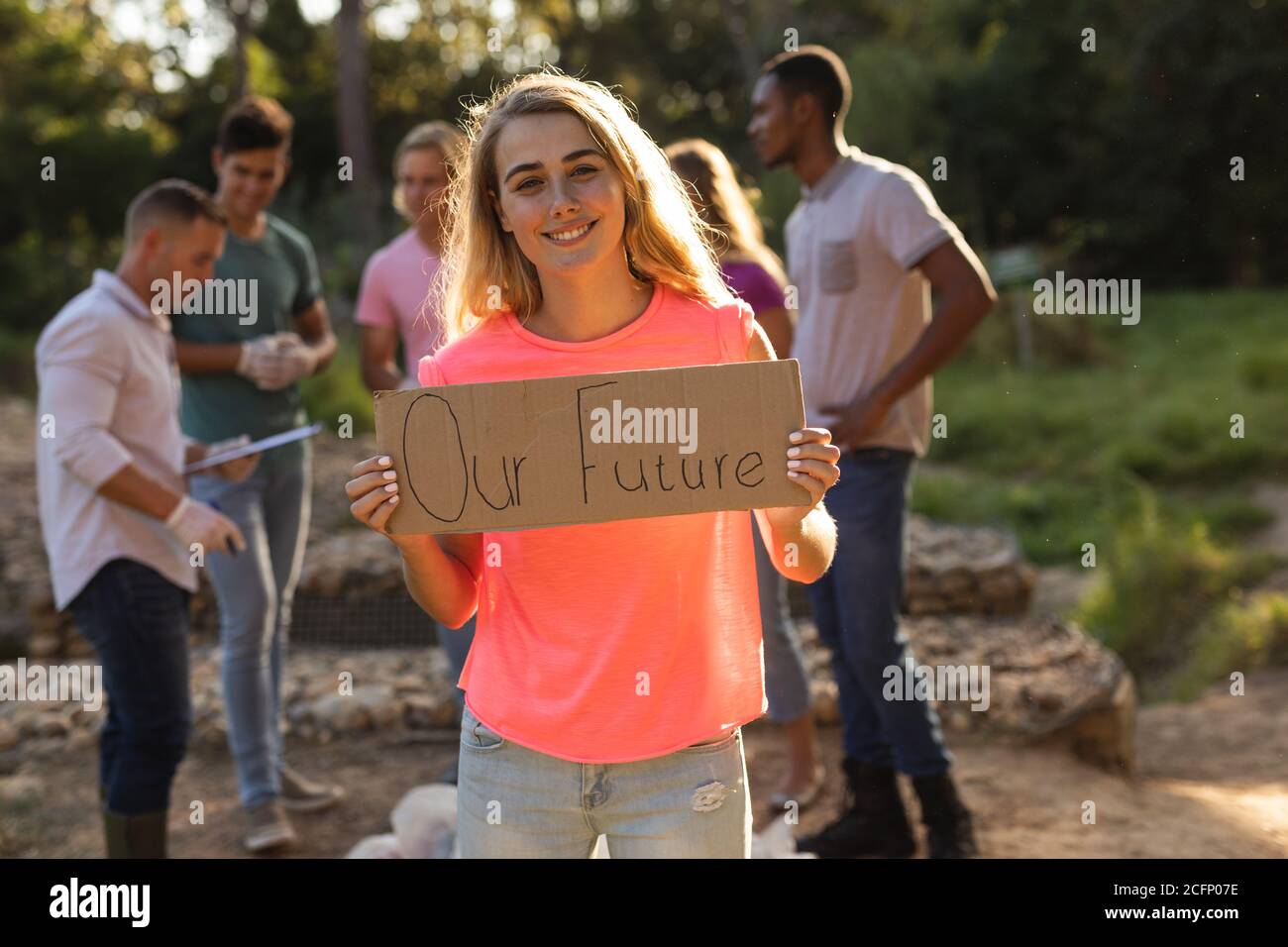 Volunteer cleaning up the countryside with board Our Future Stock Photo