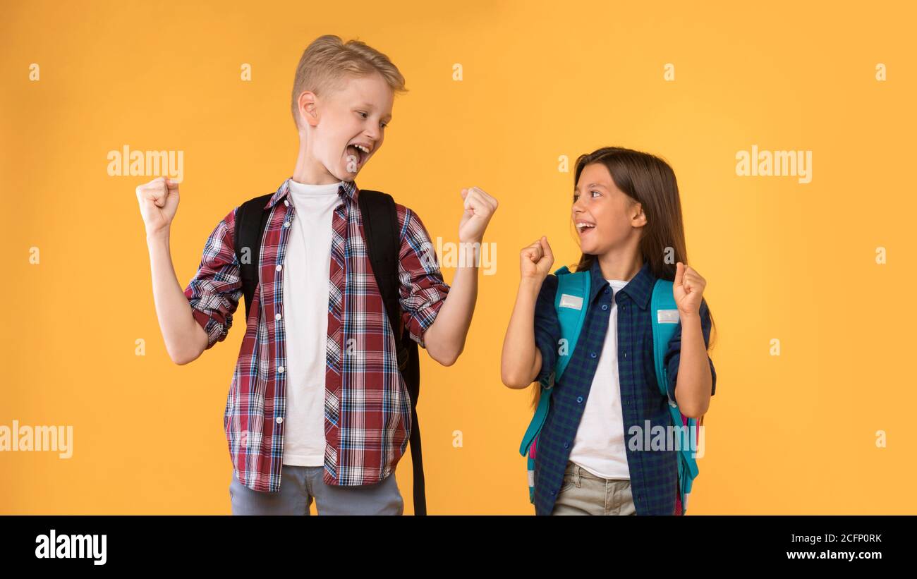 Excited boy and girl screaming with joy shaking fists Stock Photo