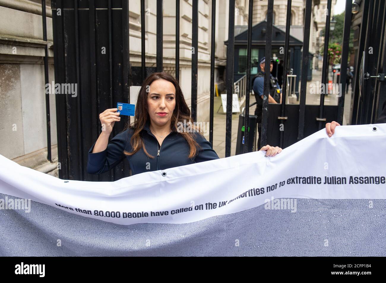 Stella Morris holds up a Julian Assange press card outside the gates of Downing Street, in Westminster, London, after attempting to deliver a Reporters Without Borders petition against the extradition of her partner, Wikileaks founder Julian Assange, to the US. Stock Photo