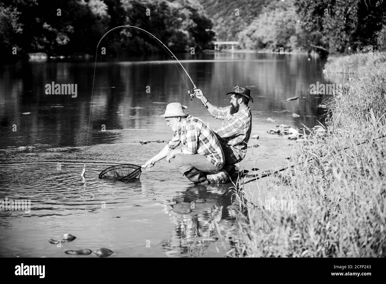 Spinnerbait. fly fish hobby of men in checkered shirt. retirement fishery. happy  fishermen friendship. Two male friends fishing together. Catching and  fishing. retired dad and mature bearded son Stock Photo - Alamy