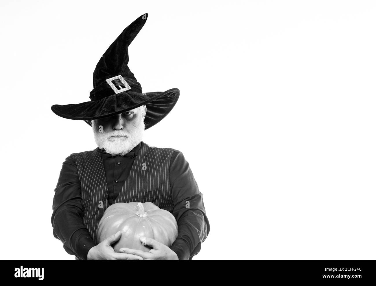 Magic concept. Experienced and wise. Halloween tradition. Wizard costume hat Halloween party. Magician witcher old man. Senior man white beard celebrate Halloween with pumpkin. Cosplay outfit. Stock Photo