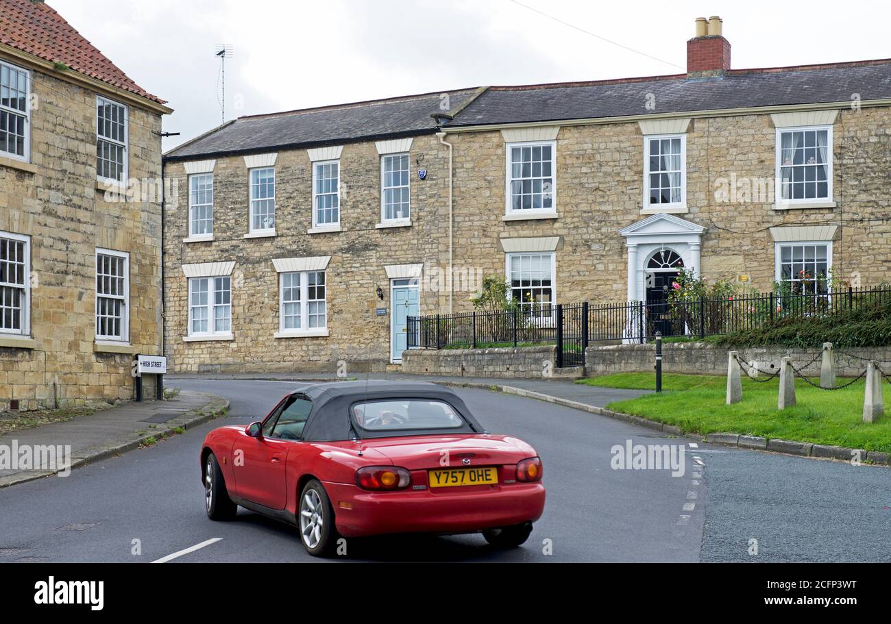 Red Mazda MX-5 in the village of Clifford, North Yorkshire, England UK Stock Photo