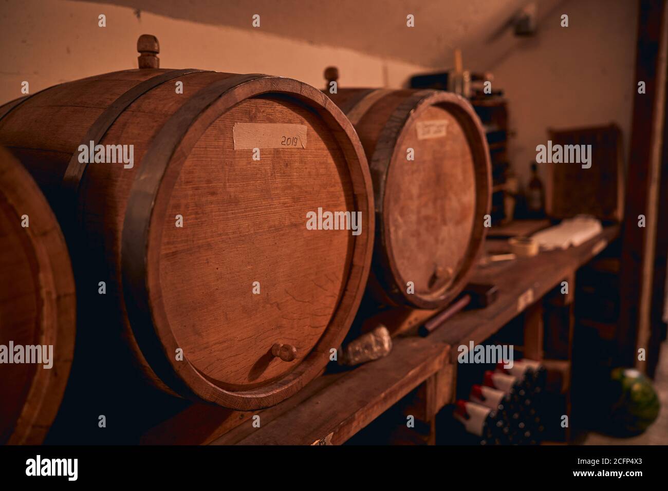 Traditional oak barrels with wine in storage room Stock Photo Alamy