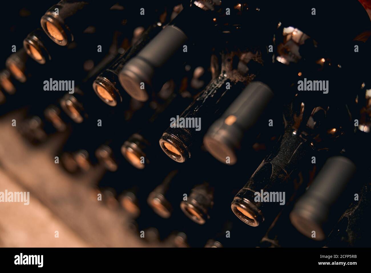 Dusty bottles of red wine in wine cellar Stock Photo Alamy