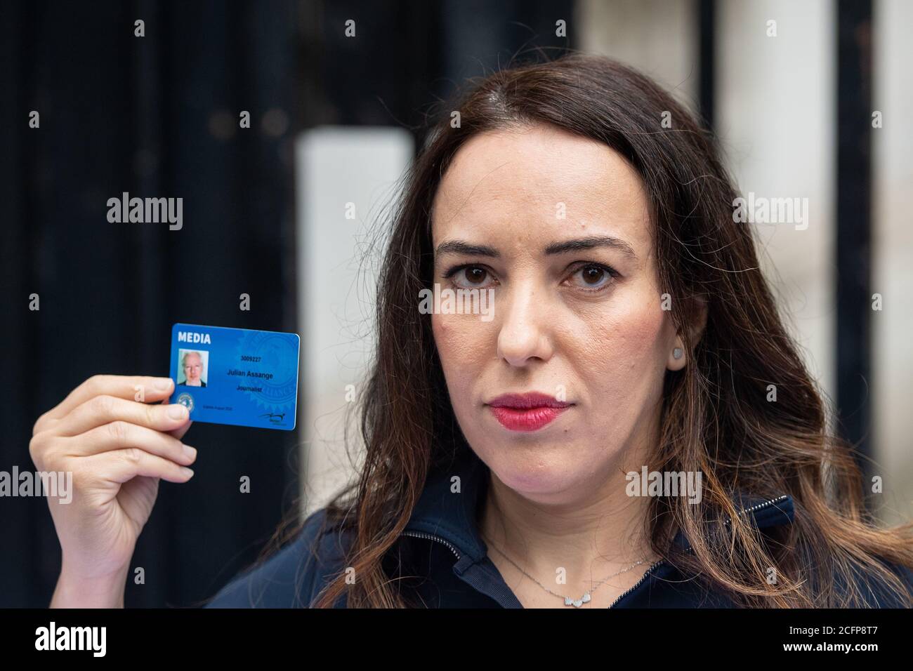 Stella Moris holds up a Julian Assange press card outside the gates of Downing Street, in Westminster, London, after attempting to deliver a Reporters Without Borders petition against the extradition of her partner, Wikileaks founder Julian Assange, to the US. Stock Photo