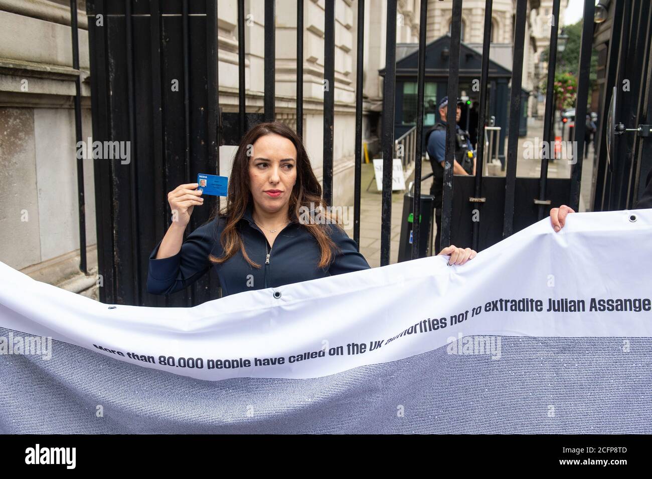 Stella Moris holds up a Julian Assange press card outside the gates of Downing Street, in Westminster, London, after attempting to deliver a Reporters Without Borders petition against the extradition of her partner, Wikileaks founder Julian Assange, to the US. Stock Photo