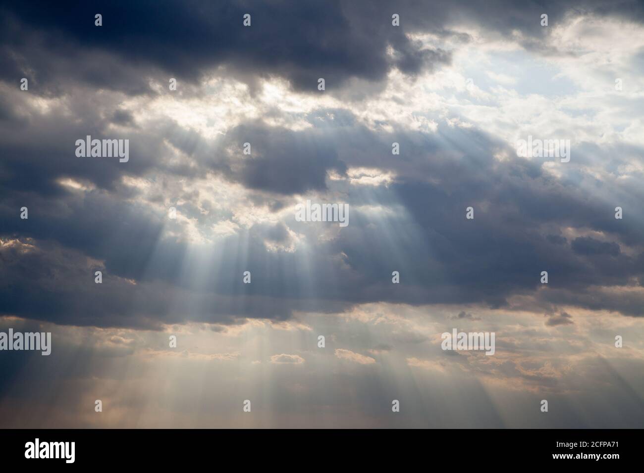 Cloudy blue sky with sunrays Stock Photo