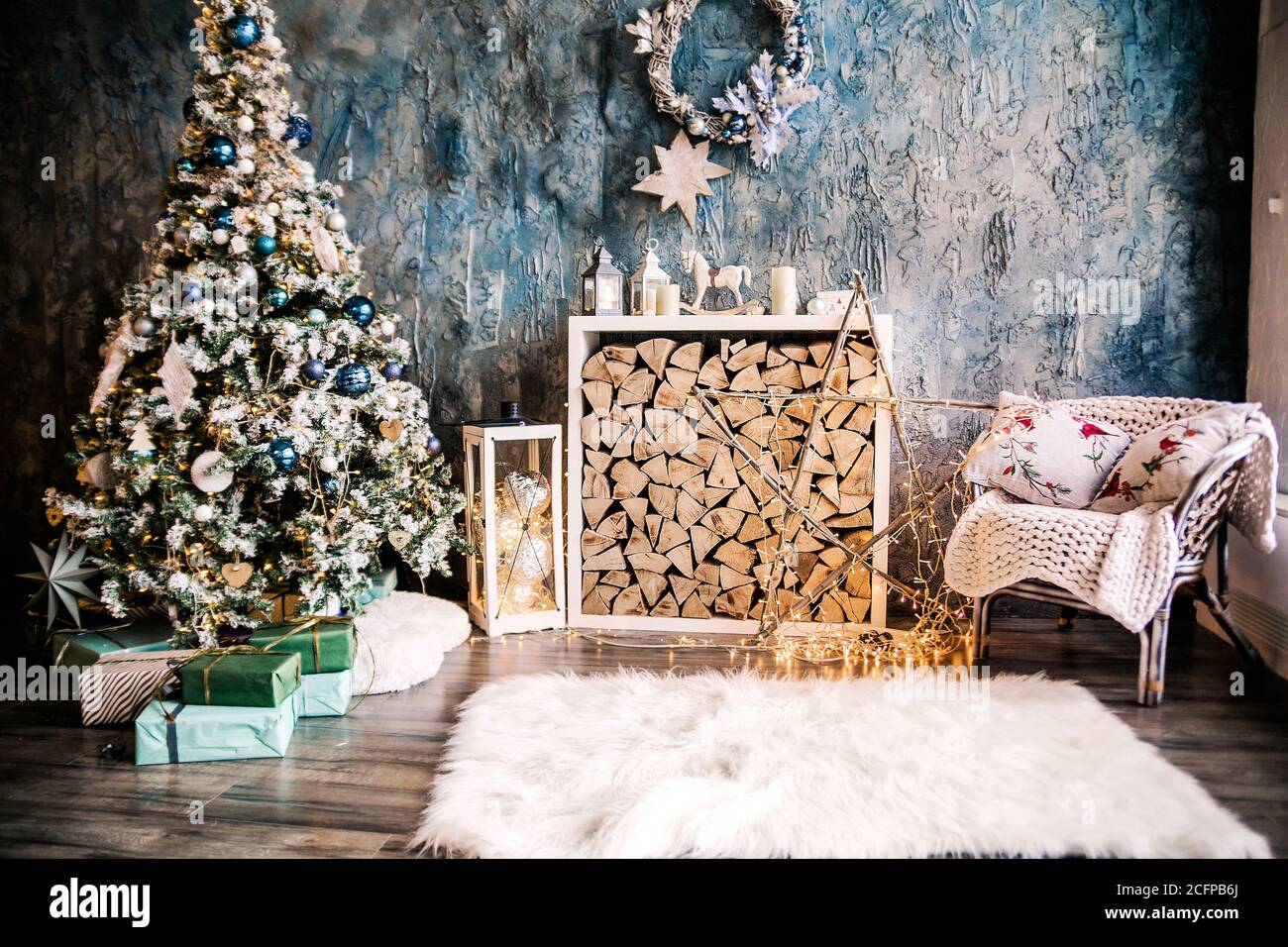 Christmas Tree With Gifts By The Fireplace For The New Year Decor Of The House 2021 2022 Stock Photo - Alamy