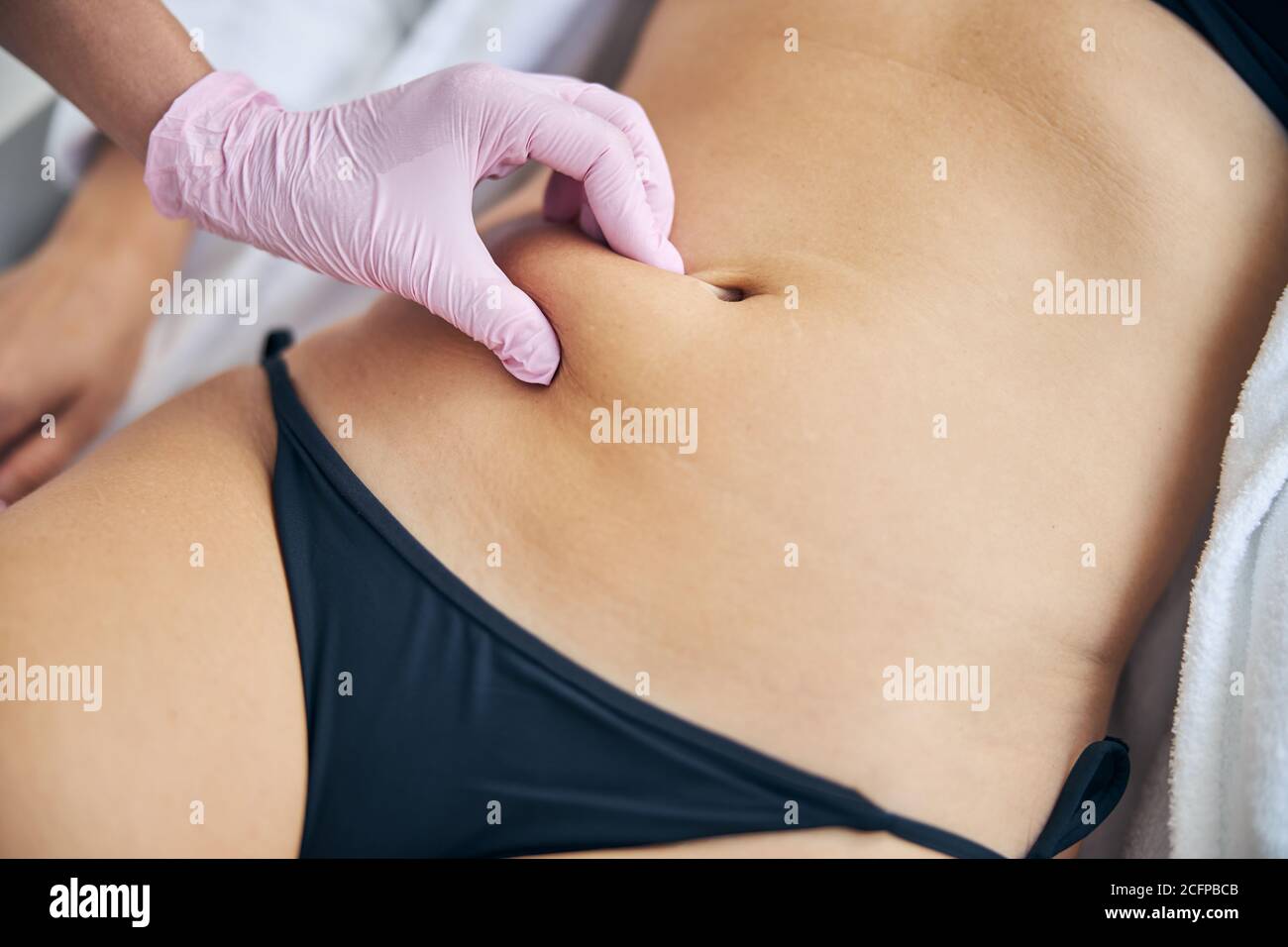 Professional dermatologist examining an adult Caucasian woman Stock Photo