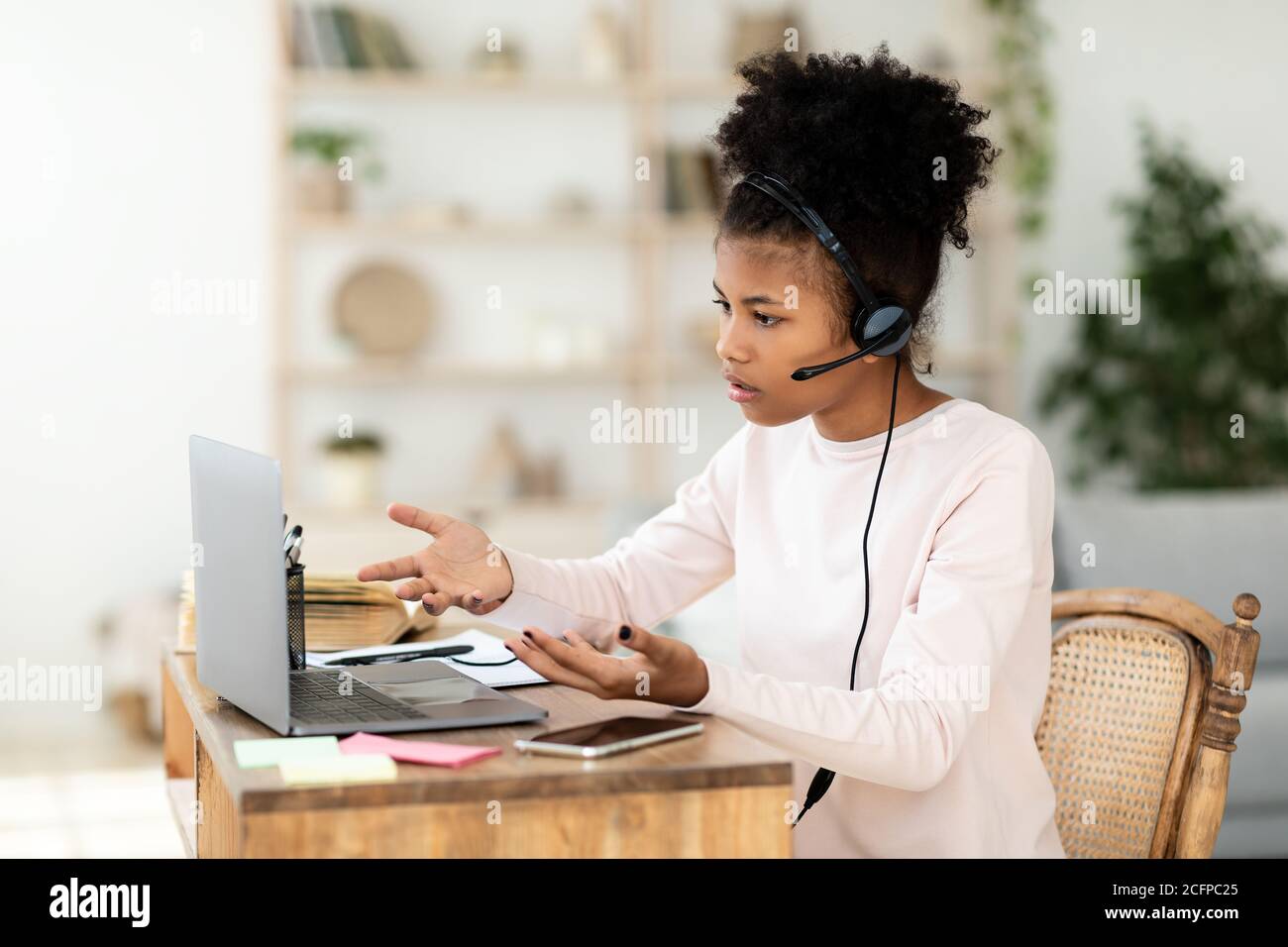 Girl Sitting At Laptop Having Video Call With Teacher Indoors Stock ...