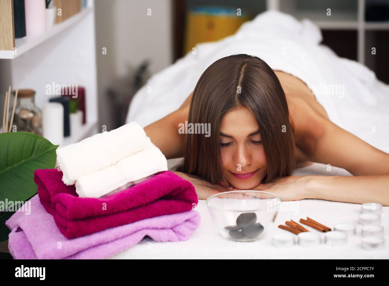 Beautiful young woman relaxing in spa salon Stock Photo - Alamy