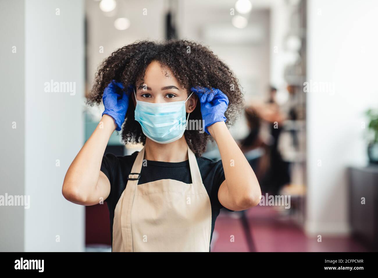 Black Woman Putting On Facemask High Resolution Stock Photography and ...