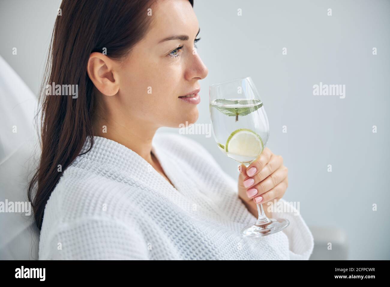 Dreamy spa client dressed in a waffle weave bathrobe Stock Photo