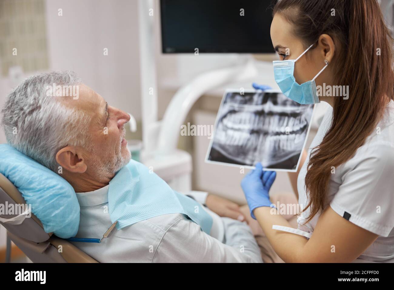Professional femaledental specialist holding a dental radiogram Stock Photo