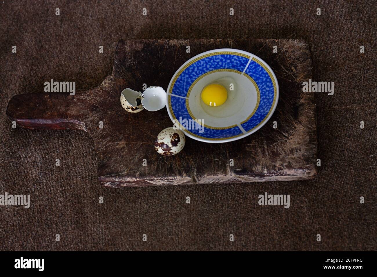 Closeup of quail eggs beside and a wooden board Stock Photo