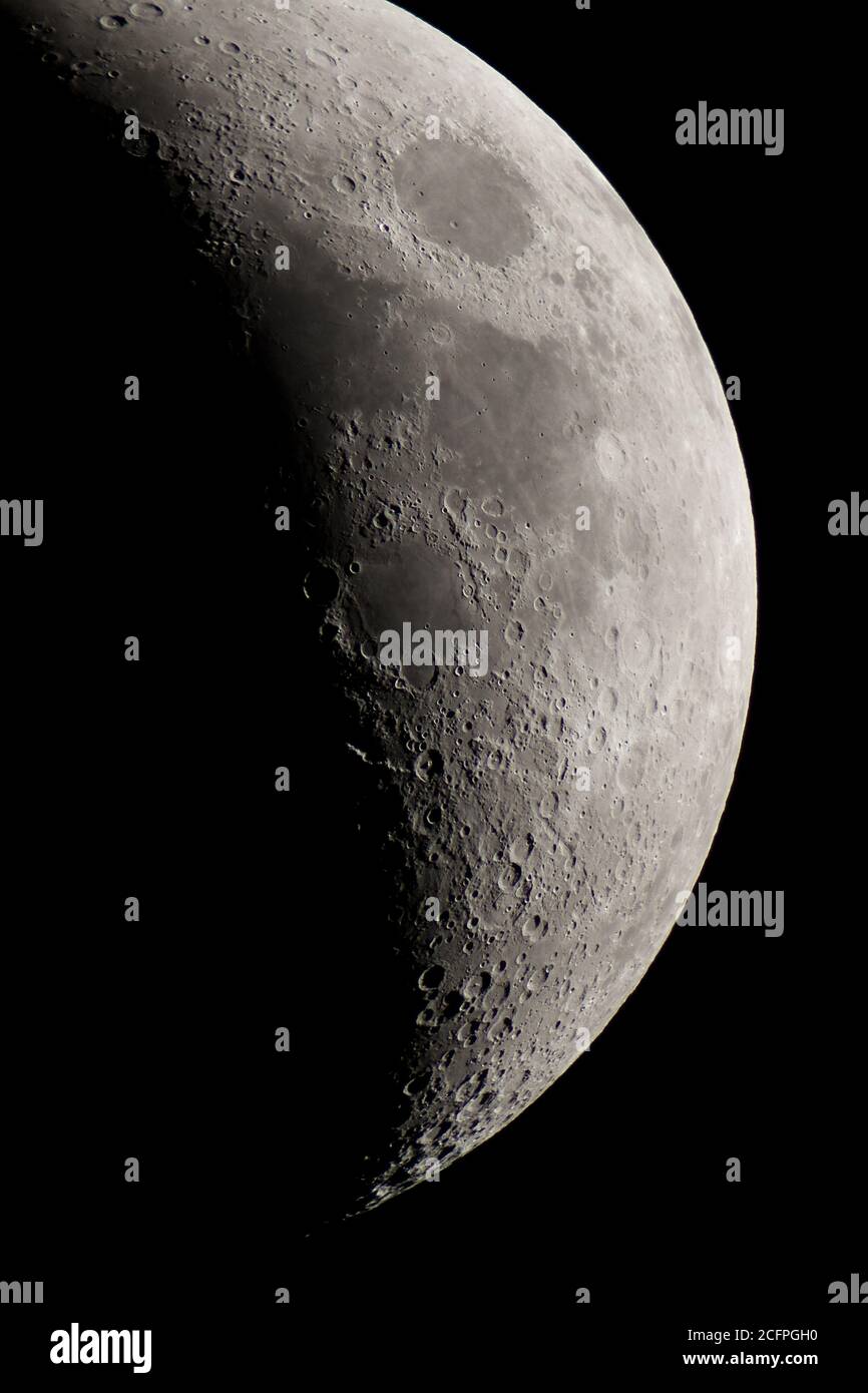 View of crescent Moon with telescope. Stock Photo