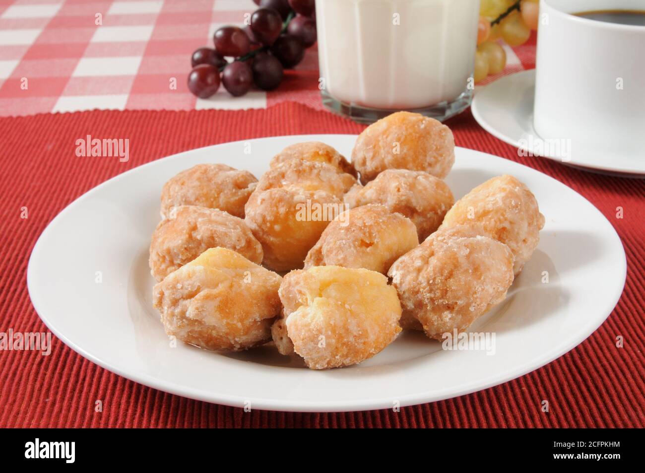 a plate of donut holes with coffee and milk Stock Photo