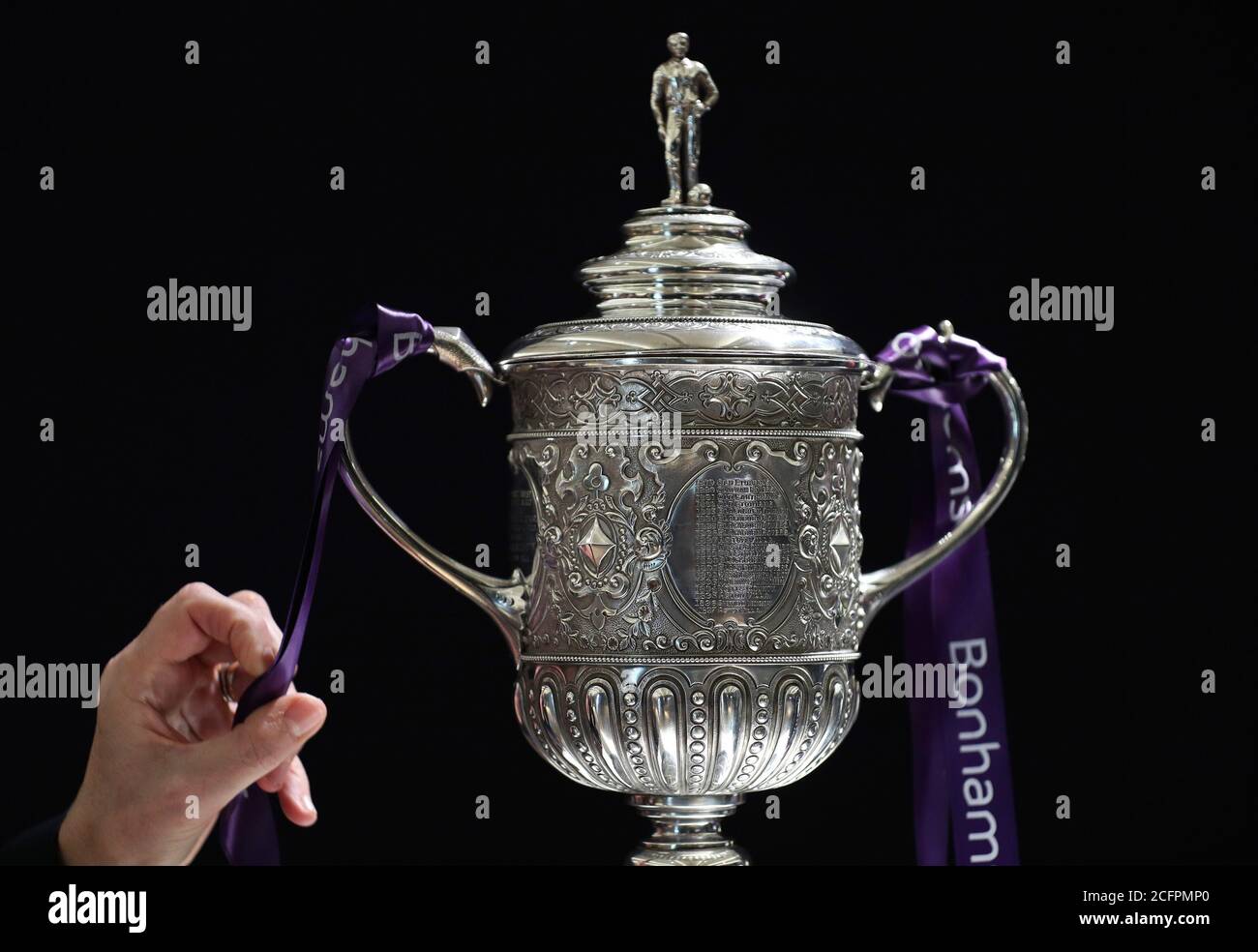 Tthe oldest surviving FA Cup trophy during a preview of the Sporting Trophies Sale at which will take place as Bonhams New Bond Street saleroom on September 29. The silver two-handled cup, estimated at GBP 700,000 -900,000, was made by Vaughton and Sons of Birmingham in 1896, and was presented to the FA Cup winning teams between 1896 and 1910, including Manchester United, Manchester City, Everton, Newcastle United and Tottenham Hotspur. Stock Photo