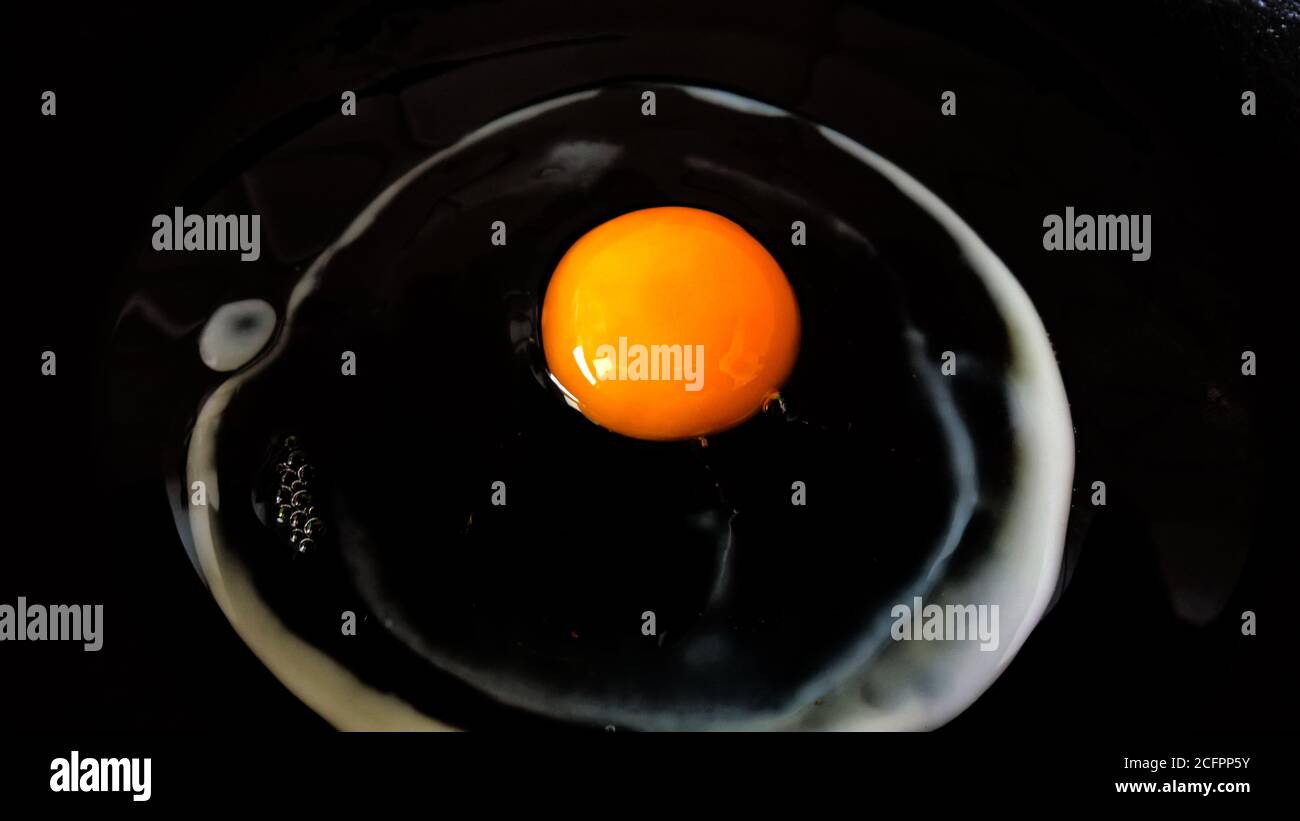 Raw egg in a cooking pan Stock Photo