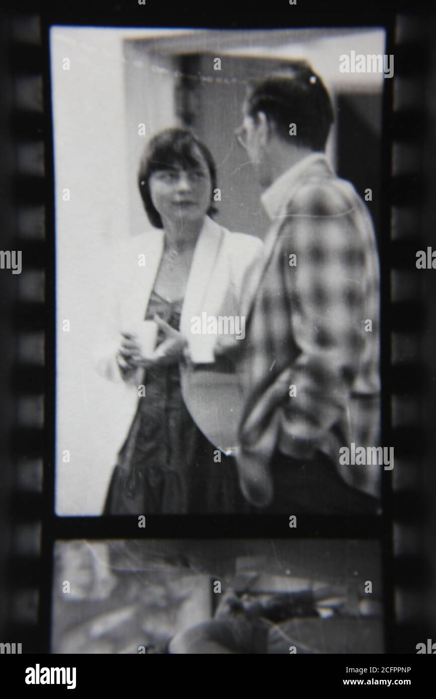 Fine 1970s vintage black and white photography of a man and a woman having a casual conversation. Stock Photo