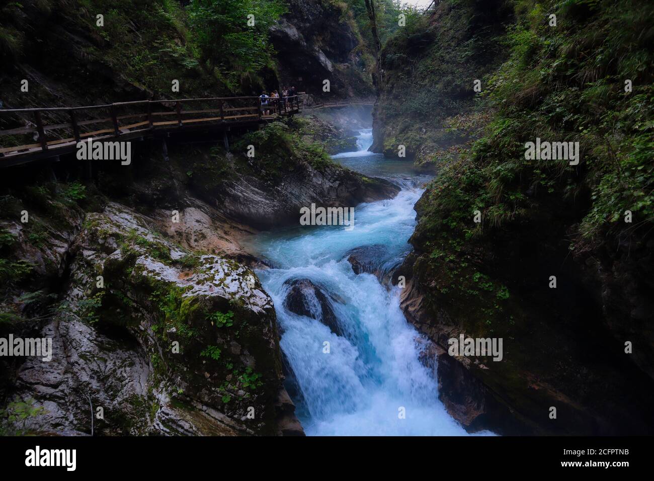 Photo of mystical Vintgar Gorge with wooden path and wild river flowing among the rocks in Slovenia Stock Photo