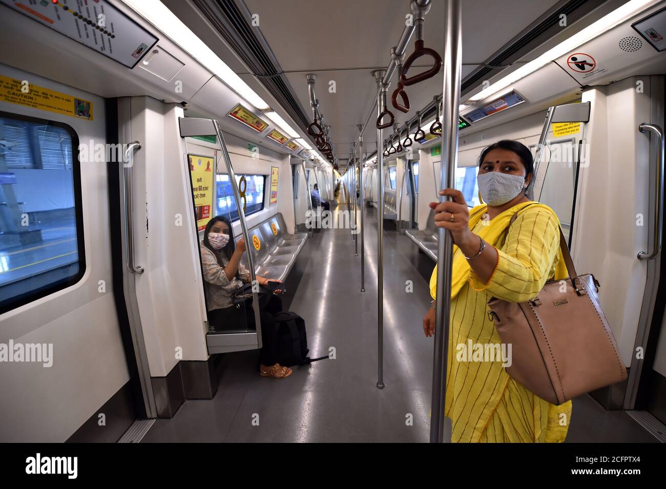 New Delhi, India. 7th September, 2020. Commuters travel in a metro train after Delhi Metro resumed services with curtailed operation of the Yellow Line and Rapid Metro, amid the ongoing corona virus pandemic, in New Delhi. India's coronavirus cases are now the second-highest in the world and only behind the United States, as the caseload crosses Brazil on a day when urban metro trains partially resume service in the capital New Delhi. Credit: PRASOU/Alamy Live News Stock Photo