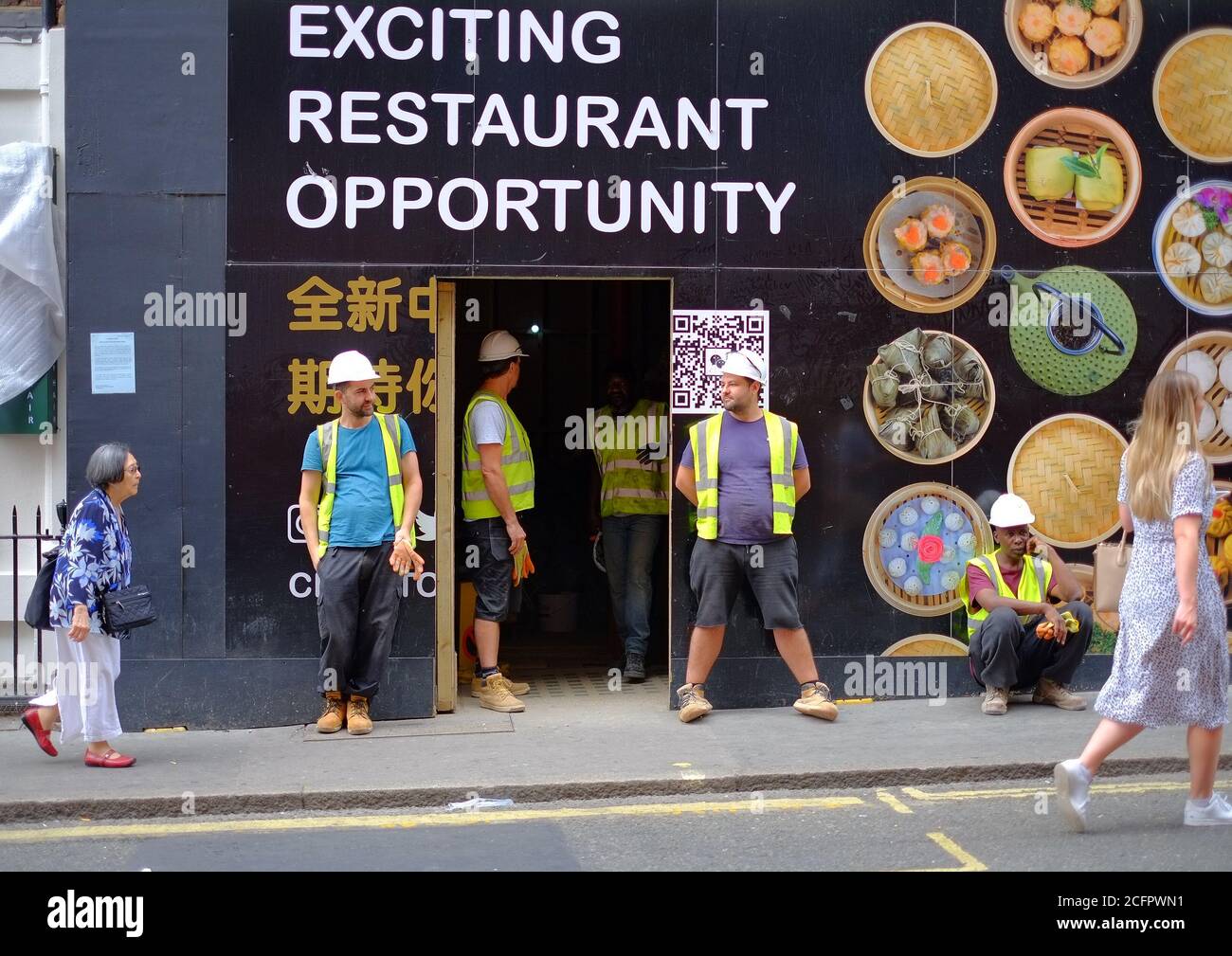 Soho Street scene, Builders outside a new Chinese restaurant, Berwick Street, London. Stock Photo
