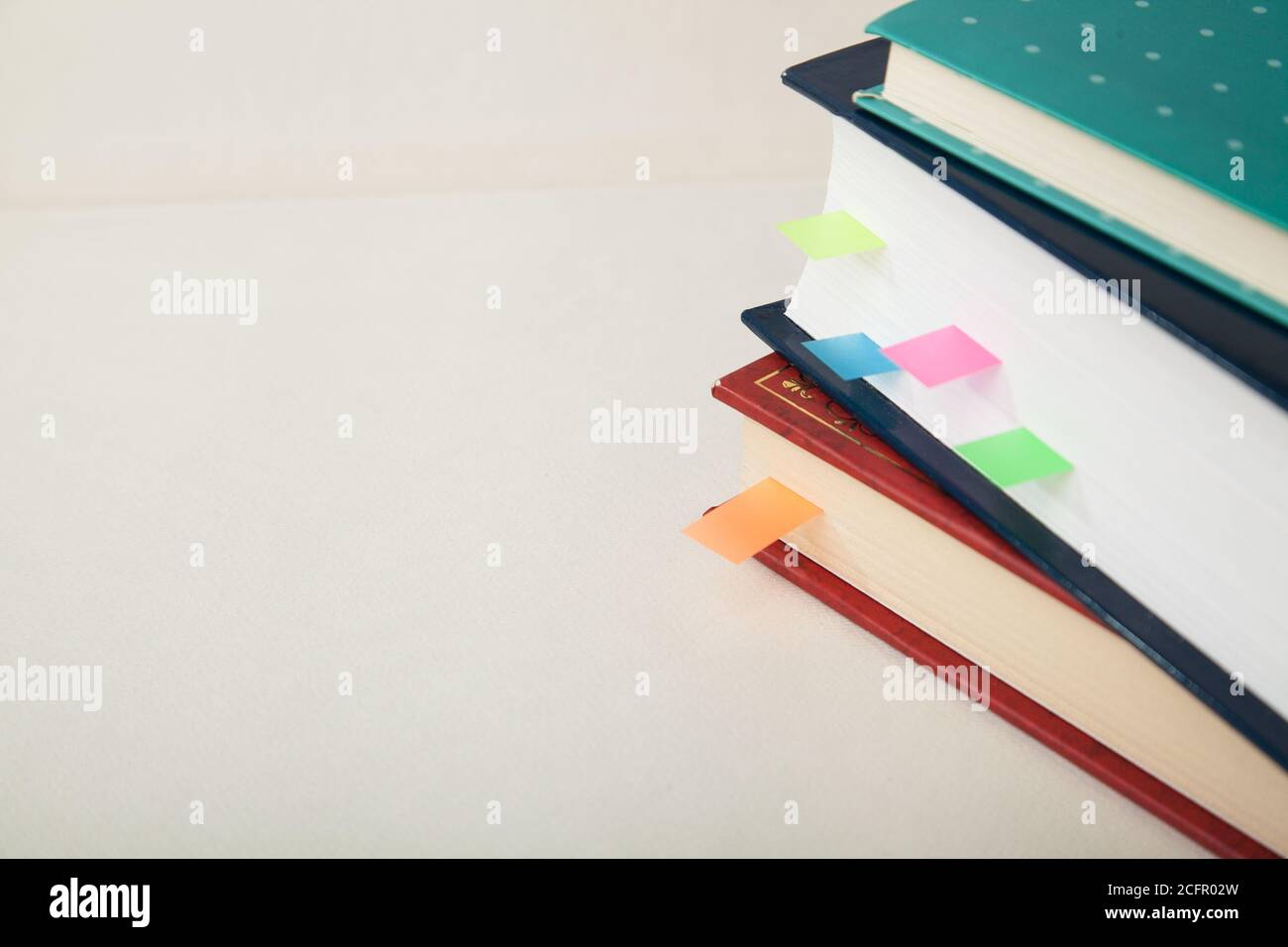 Stack of books with colored memory notes and copy space Stock Photo