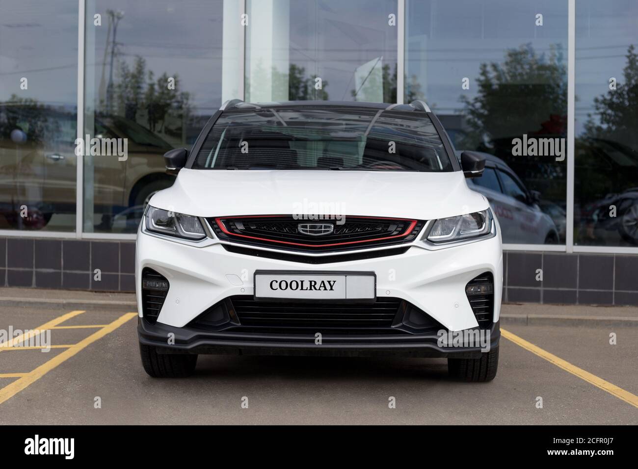 Russia, Izhevsk - August 14, 2020: Geely showroom. New modern CoolRay is standing near the dealer showroom. Front view. Car manufacturer from China. Stock Photo