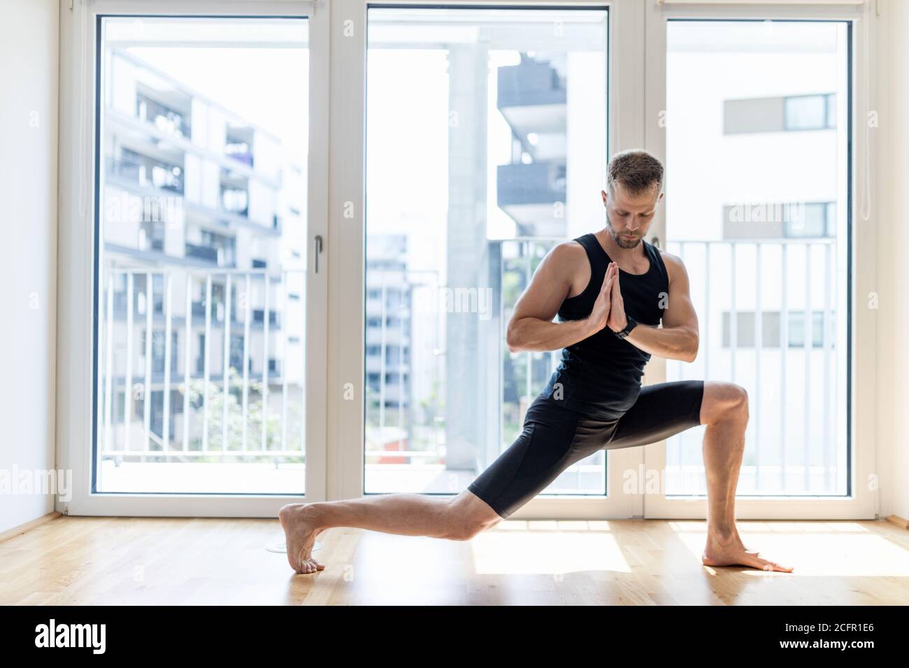 Young handsome man practicing yoga at home Stock Photo