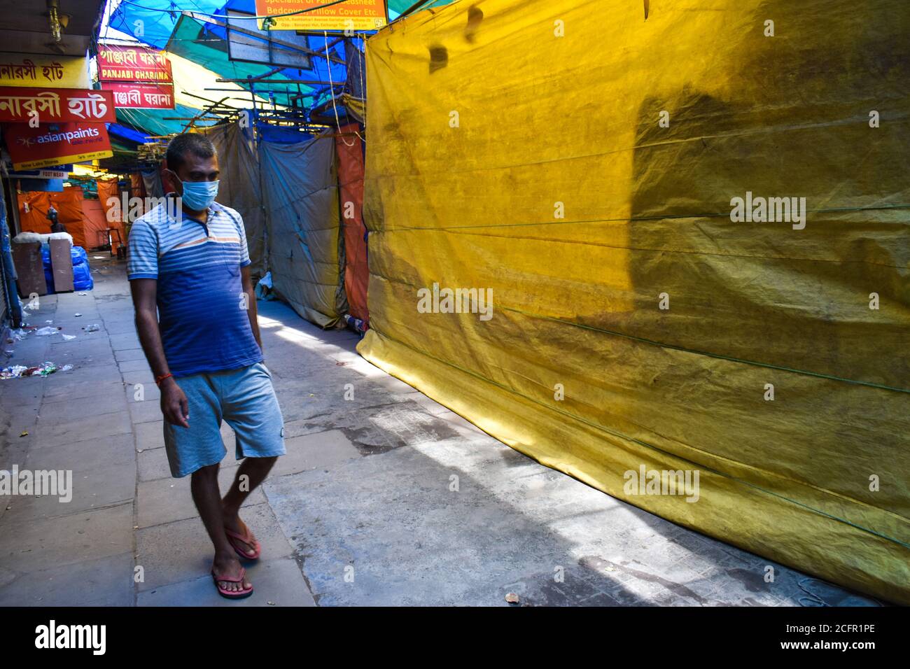 Kolkata, India. 07th Sep, 2020. A person wearing mask and walking between a closed market during the Bi- weekly lockdown in the West Bengal state, amidst the spread of the COVID-19 disease in Kolkata. India displaced Brazil to take second place after the United States in terms of coronavirus infections, with 90,082 new cases. The total number of coronavirus cases mounted to 42, 04,613, while the death toll climbed to 71,642 with 1,016 fatalities being reported in a span of 24 hours. (Photo by Sudipta Das/Pacific Press) Credit: Pacific Press Media Production Corp./Alamy Live News Stock Photo