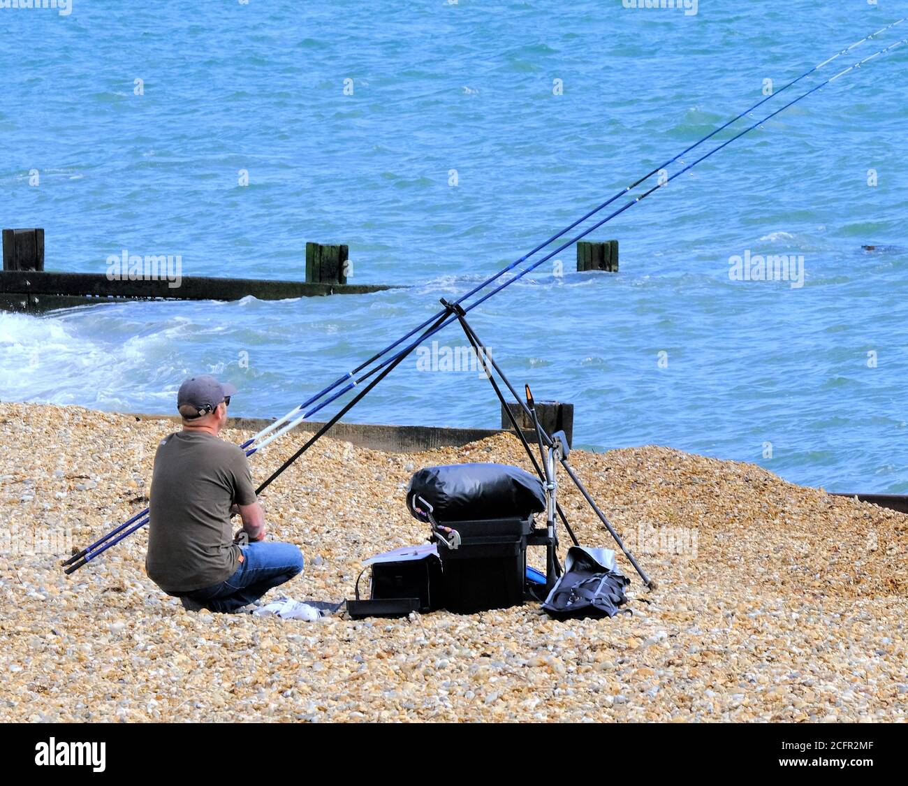 Angler on the beach at Milford-On-Sea Stock Photo