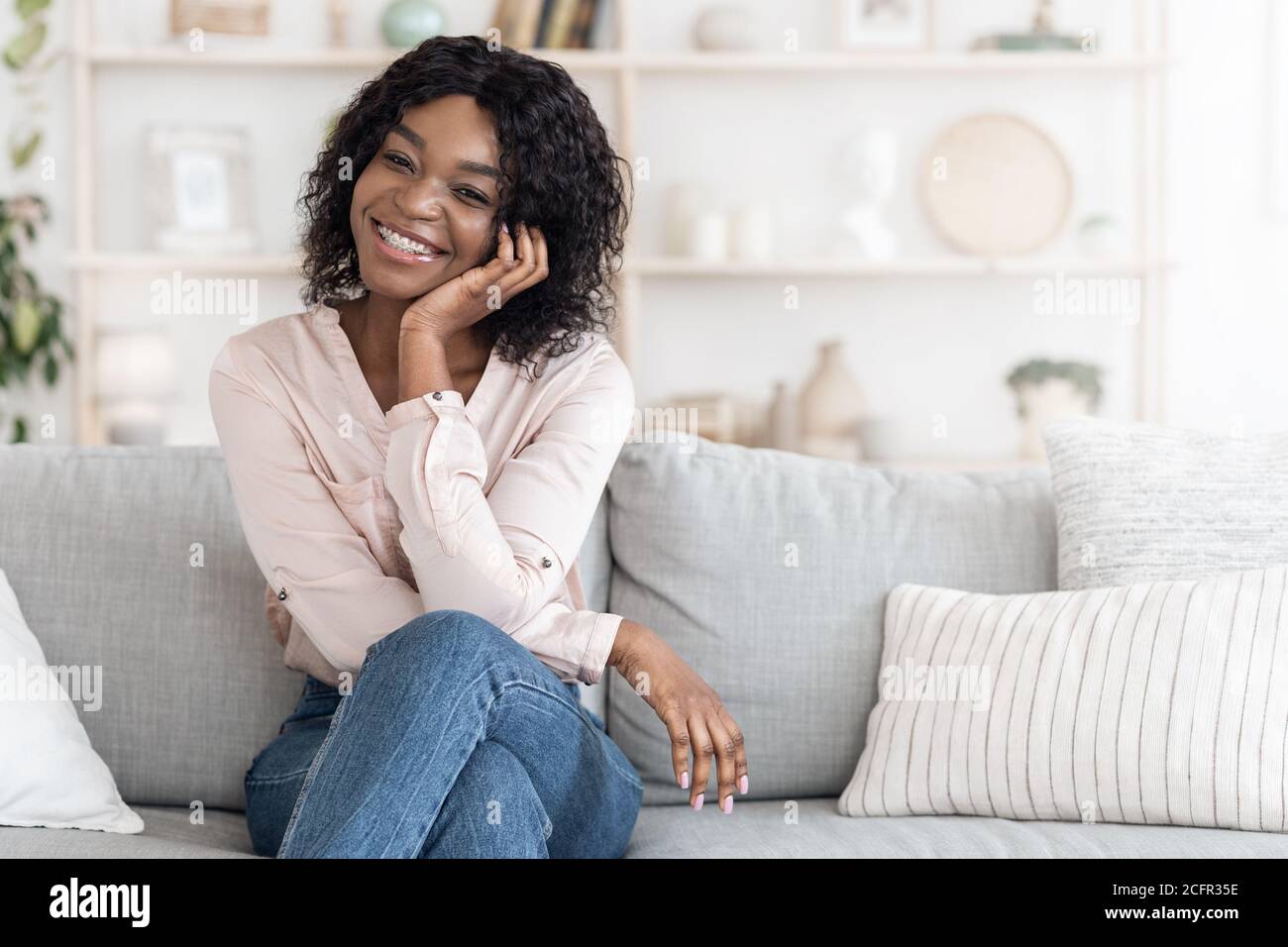 Home Portrait Of Beautiful African Woman Posing On Couch In Stylish ...