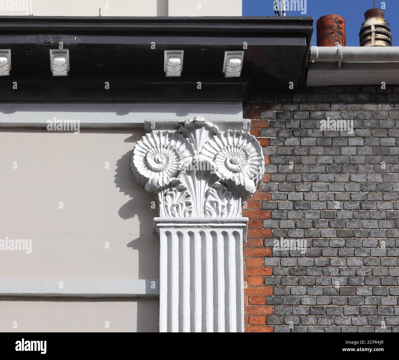 Close up of ammonite capitals on a building (Castle Place), designed by architect Amon Wilds, on Lewes High Street, East Sussex. Stock Photo