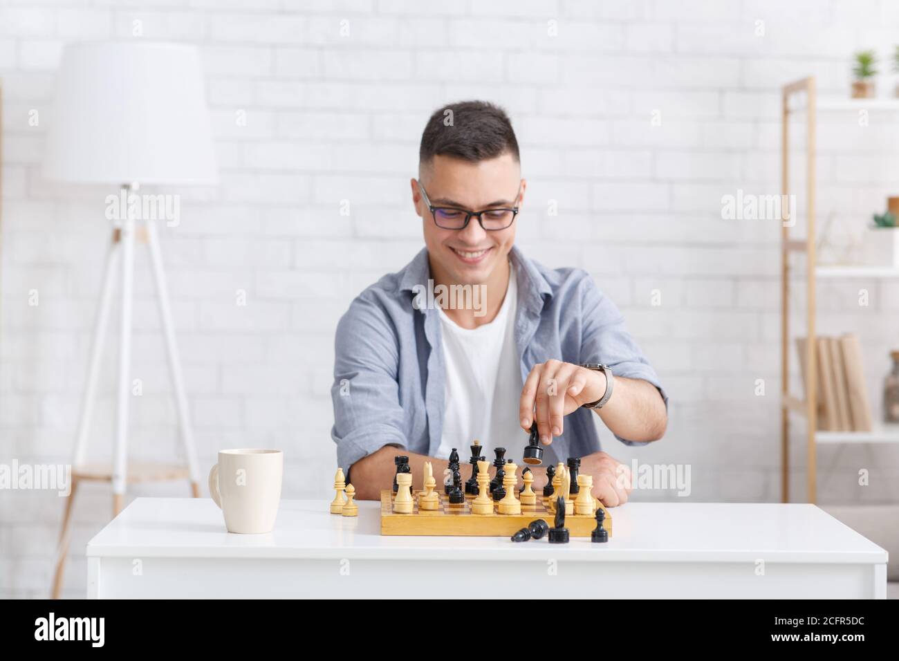 Man playing chess online on tablet computer Stock Photo