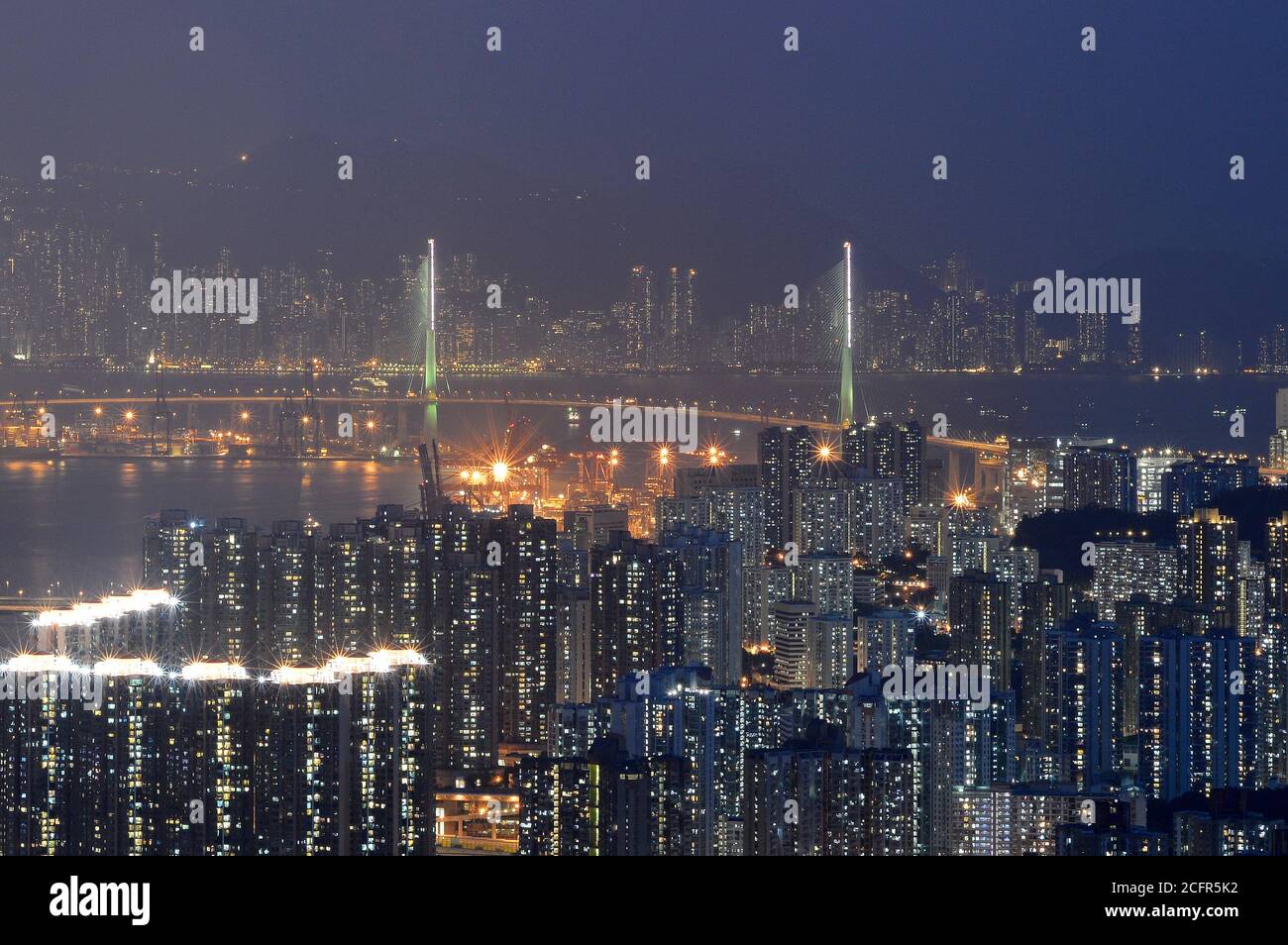 Hong Kong cable-stayed bridge (Stonecutters Bridge) and residential area (Tsing Yi) at night Stock Photo