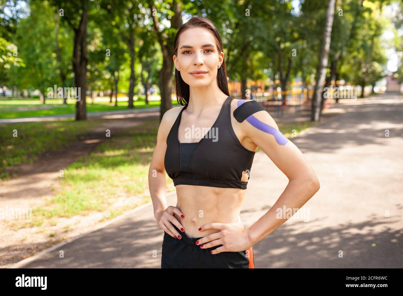 Sporty woman with perfect athletic body posing on sportsground Stock Photo  - Alamy