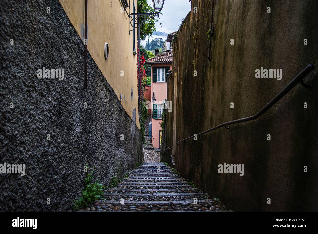 Very narrow street in some small town on Lake Como, located in Northern Italy. Stock Photo