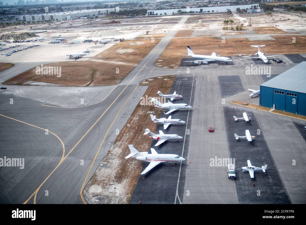 Aerial drone photo of airplanes as seen from above docked in airport space, travel concept. Stock Photo
