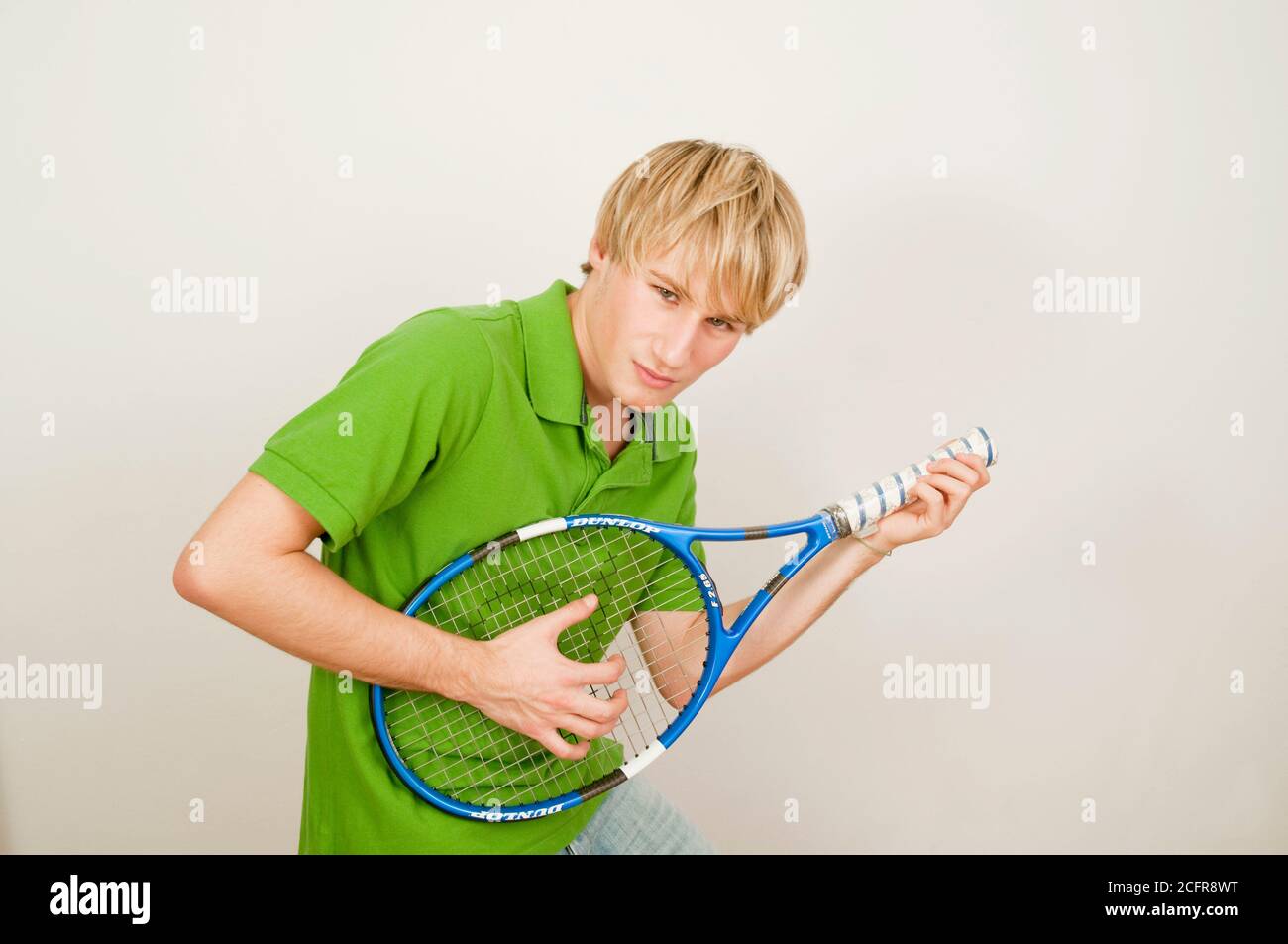 Young man playing a tennis racket as a guitar Stock Photo - Alamy