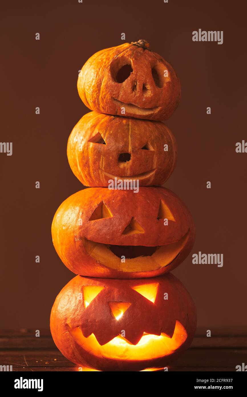 Group of four spooky handmade Jack O' Lantern pumpkins tower ...