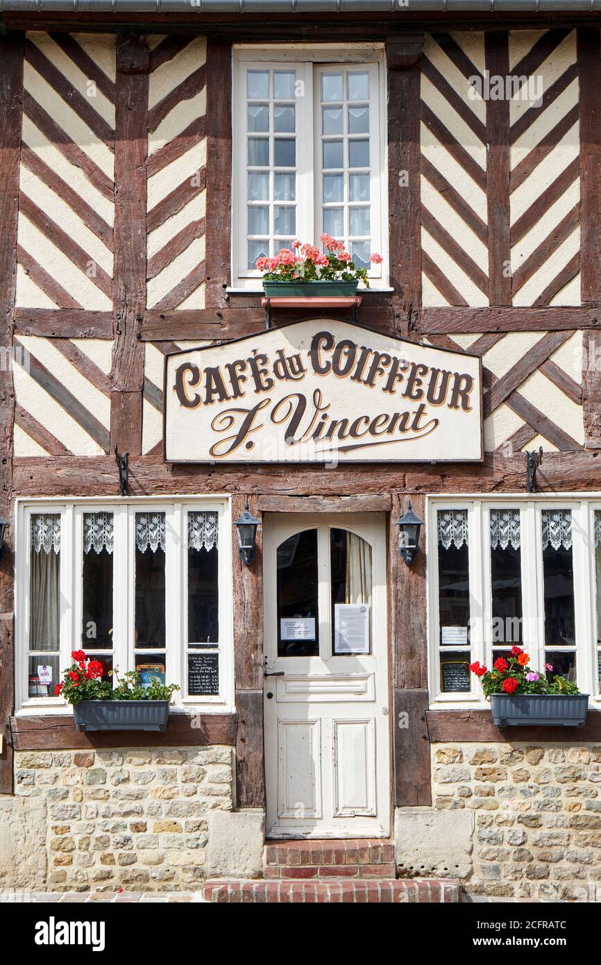 Half-timbered facade of  'Café du Coiffeur' in the picturesque french village of Beuvron-en-Auge Stock Photo