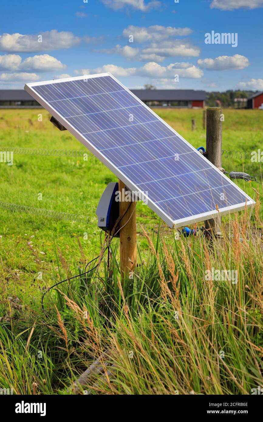 Solar panel electric fence charger mounted on a wooden pole providing the  energy for electrical livestock fencing on rural farmland in Finland Stock  Photo - Alamy