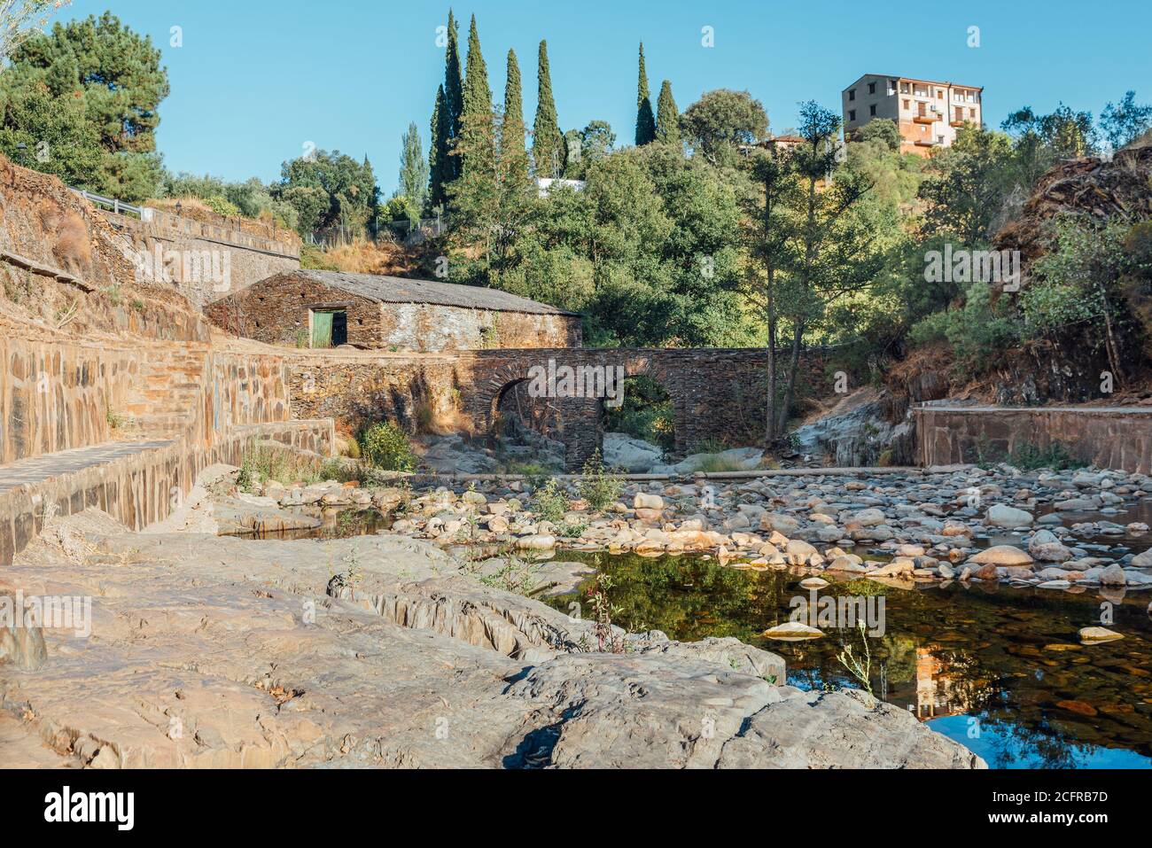 Roman bridge and natural pool in Las Mestas, Caceres, Extremadura, Spain Stock Photo