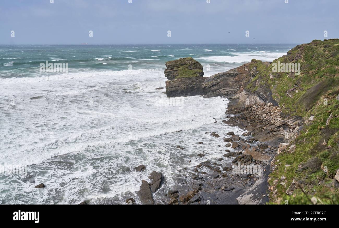 Waves crashing into cliffs following a storm at Broadhaven, Pembrokeshire, Wales Stock Photo