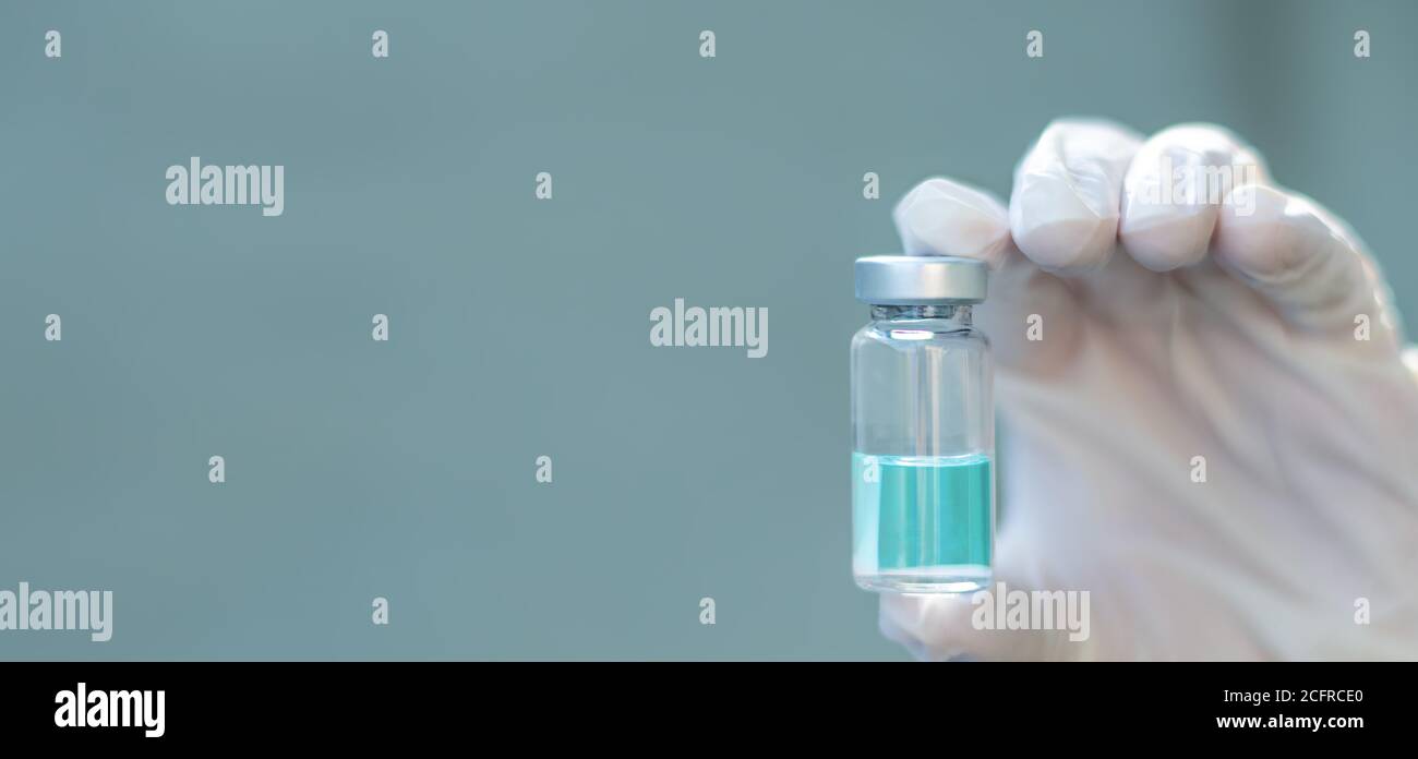 Biology and science. Scientist holding a vaccine vial. Global alert. Vaccination. Covid-19. Coronavirus. Research. Stock Photo